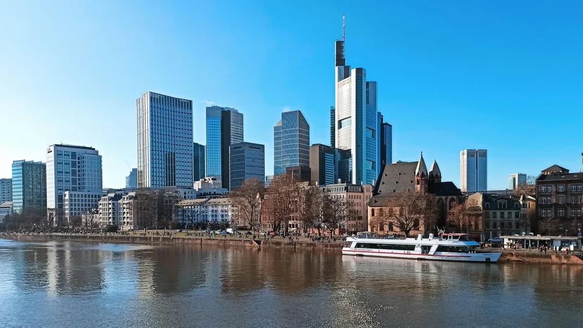Transferhood — Frankfurt: Your Gateway to the Rhine and Beyond (the skyscraper skyline and a boat on the river Main)