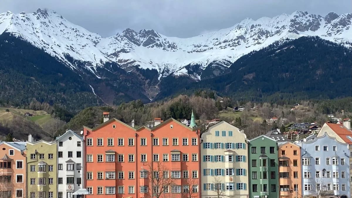 Transferhood — Innsbruck: Your Gateway to the Tyrolean Alps (colorful old-town houses beneath the snowy Nordkette range)